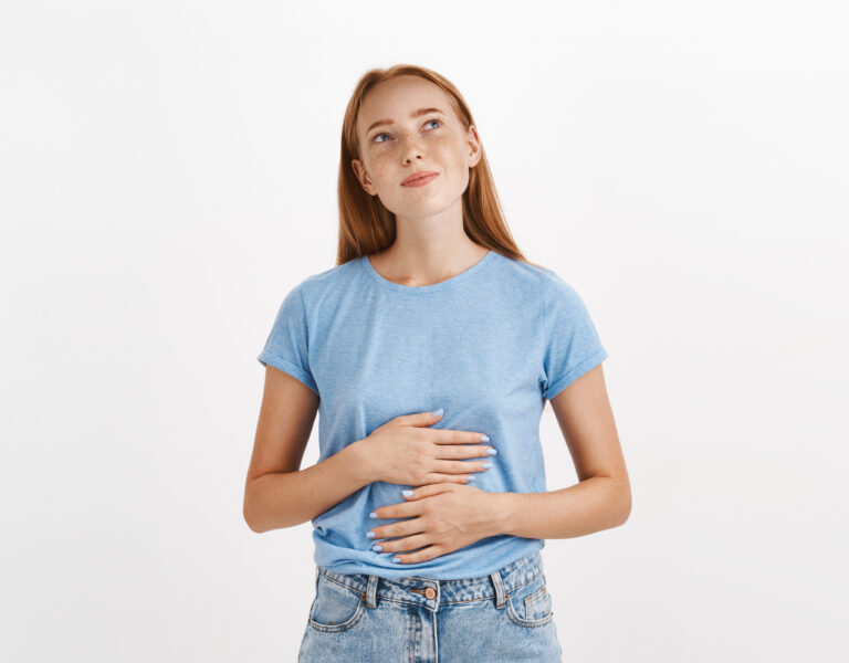 Contemplative Young Woman With Her Hands On Her Stomach