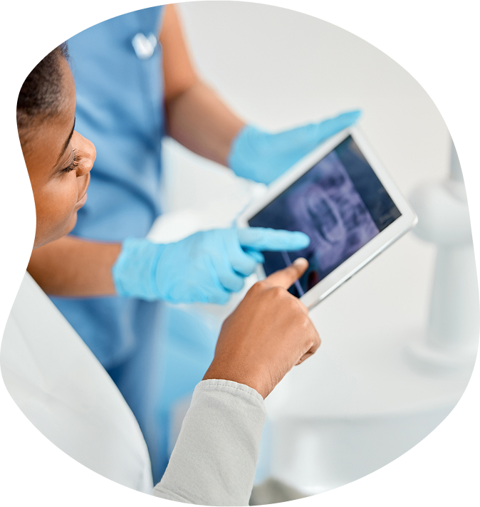 Doctor And Technician Examining Teeth Xray