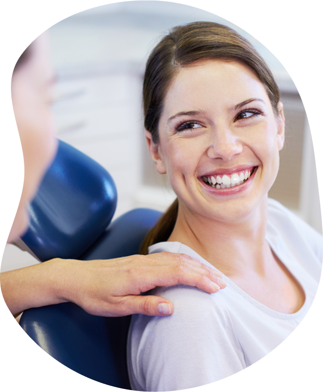 Doctor With Smiling Patient Sitting In Examination Chair