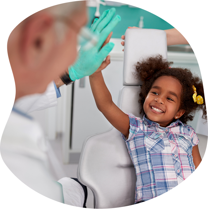 Doctor With Young Smiling Female Patient Giving A High Five