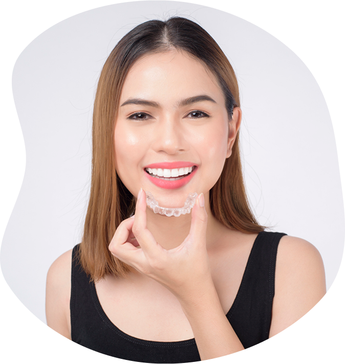 Smiling Young Woman Holding Clear Aligner