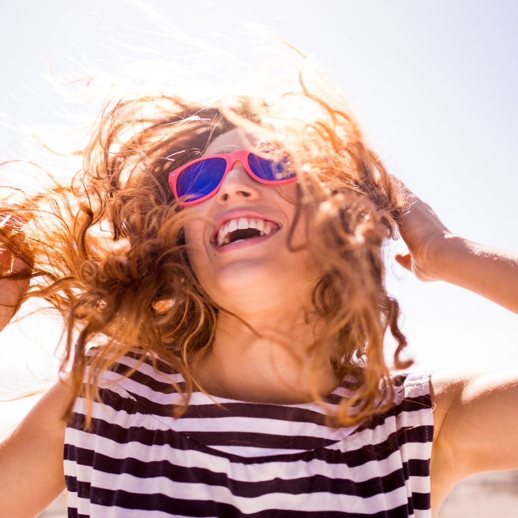 Cheerful Laughing Woman On The Beach