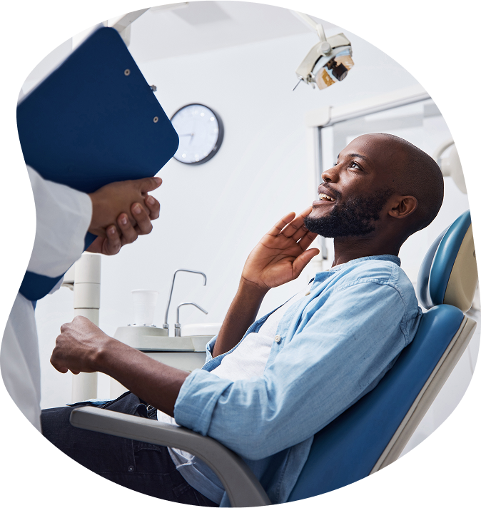 Smiling Man Discussing Teeth Issues With Orthodontist