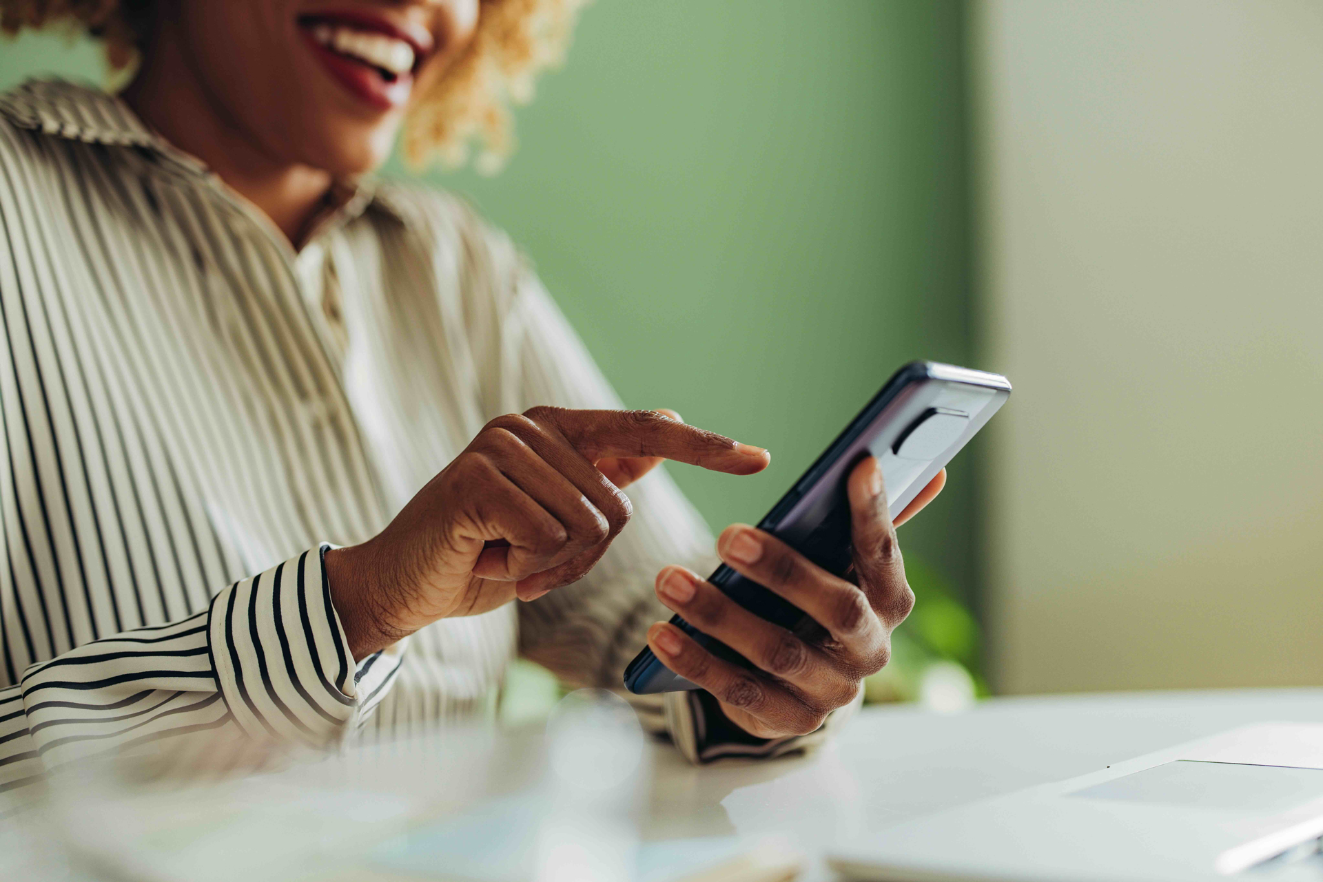 Smiling Woman Filling Out Form Using Her Phone