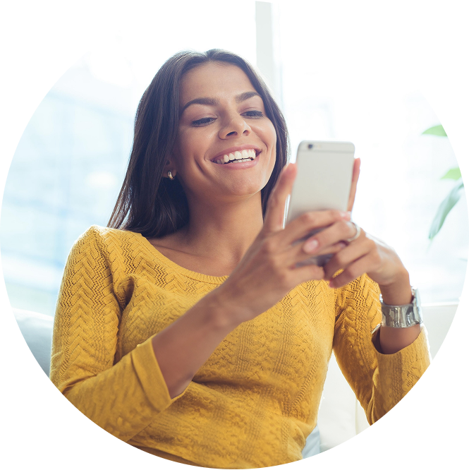 Smiling Woman Looking At Her Phone