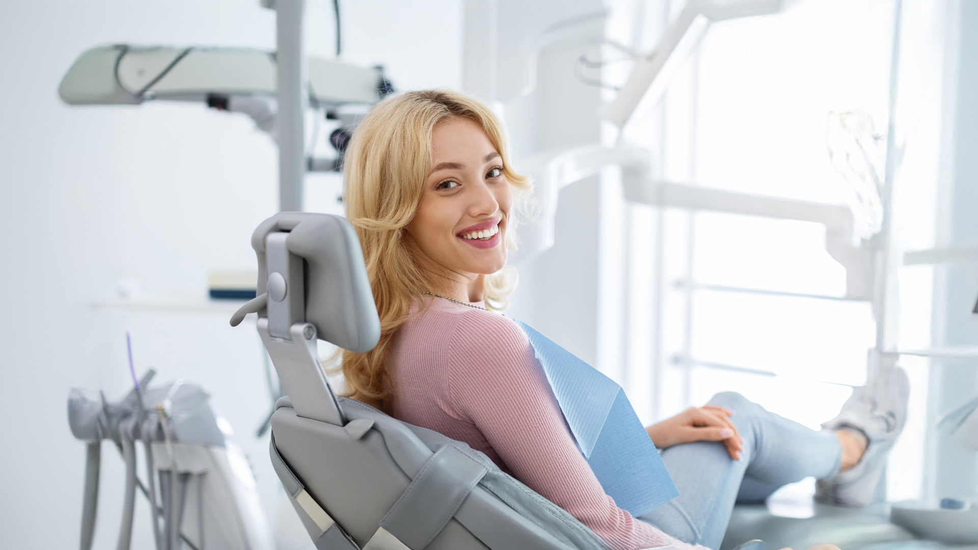 Smiling Woman Sitting In Orthodontist Chair