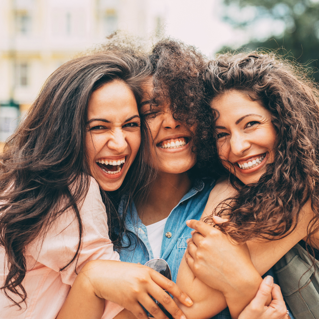 Three Smiling Women In Outdoor Market