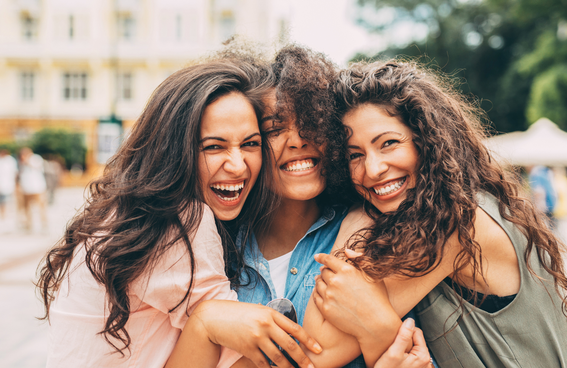 Three Smiling Women In Outdoor Market