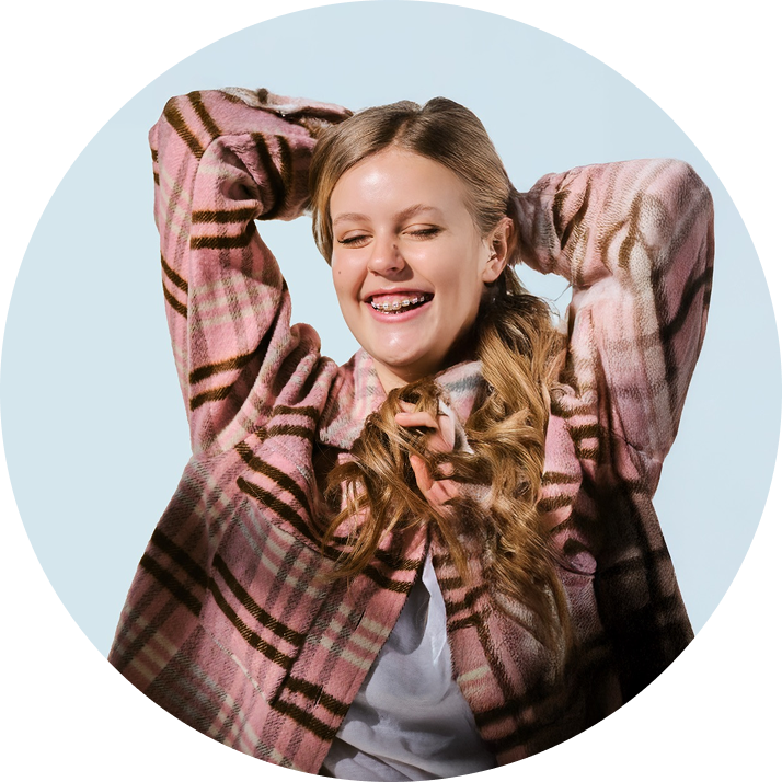 A girl smiling with LightForce Braces