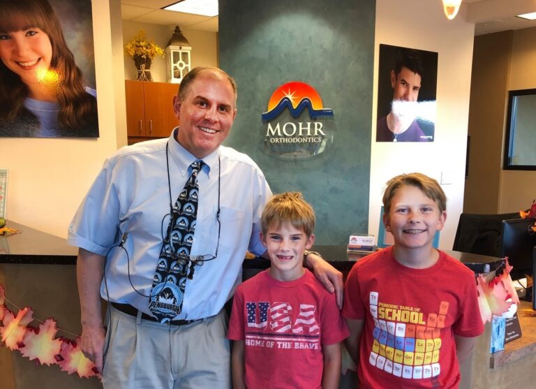 Dr. Mohr with two patients with braces