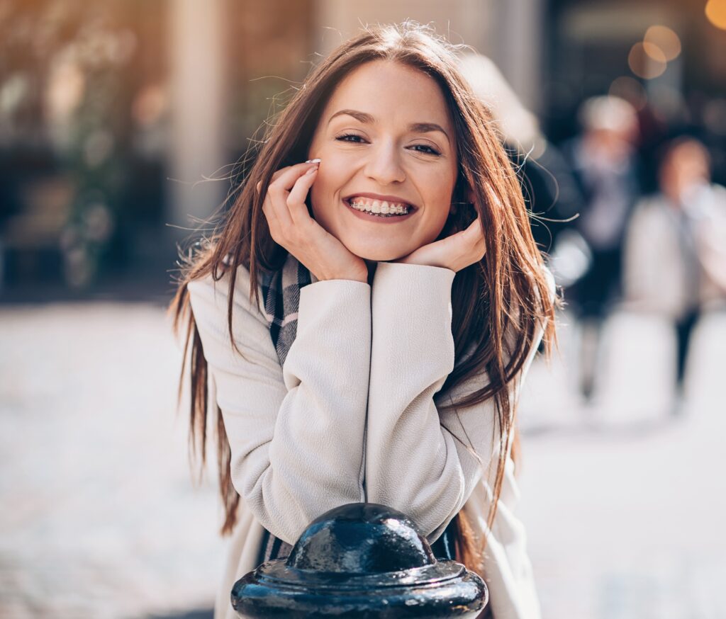 woman with braces leaning and smiling
